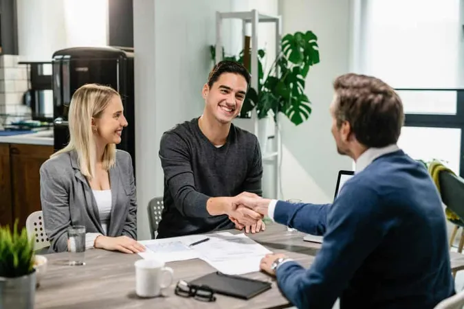 Young Happy Couple Making Agreement With Their Financial Advisor Home Men Are Shaking Hands X - Certified Claims Professional study guide