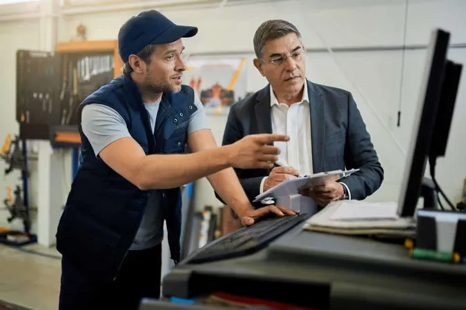 Mid Adult Manager Car Mechanic Talking While Using Computer Auto Repair Shop 1 X - Certified Commissioning Professional study guide