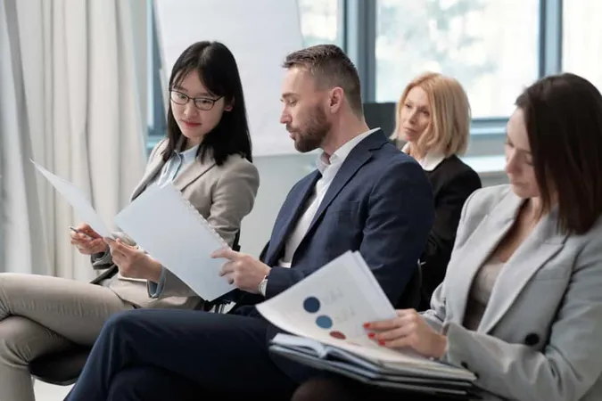 Young Businessman Showing His Report Asian Female Colleague Conference X - Certified Career Strategist study guide