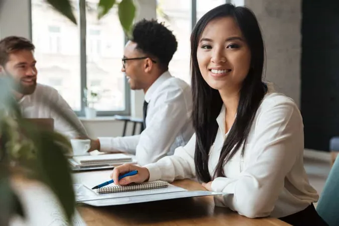Cheerful Young Asian Businesswoman Near Colleagues X - Certified Administrative Manager study guide