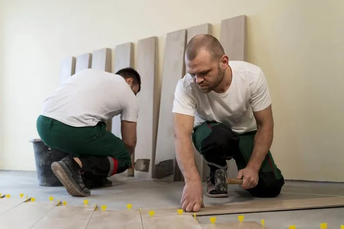 Full Shot Workers Tiling Floor Indoors X - Certified Flooring Installer study guide