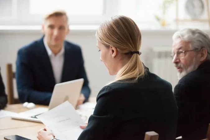 Focused Serious Businesswoman Reading Document Group Meeting Negotiations X - Certified Forensic Interviewer study guide