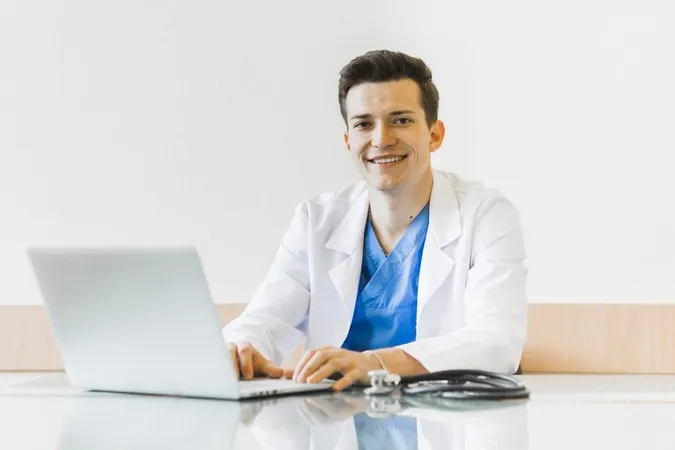Smiling Doctor Working With Laptop X - Certified Health Informatician study guide