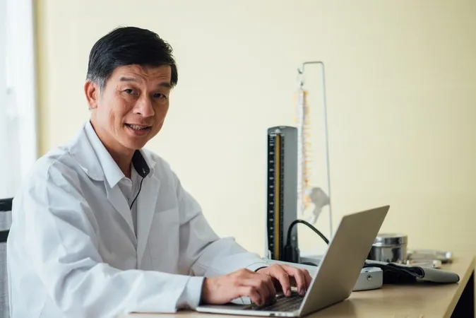 Smiling Doctor Using Laptop Table X - Certified Health Physicist study guide