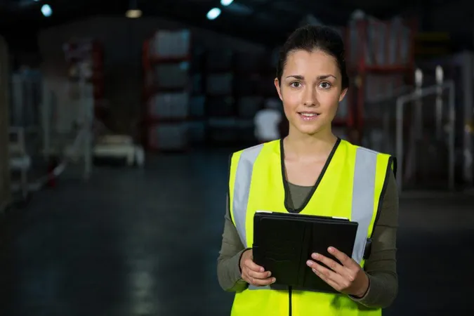 Beautiful Young Woman Using Digital Tablet Factory X - Certified Industrial Accountant study guide