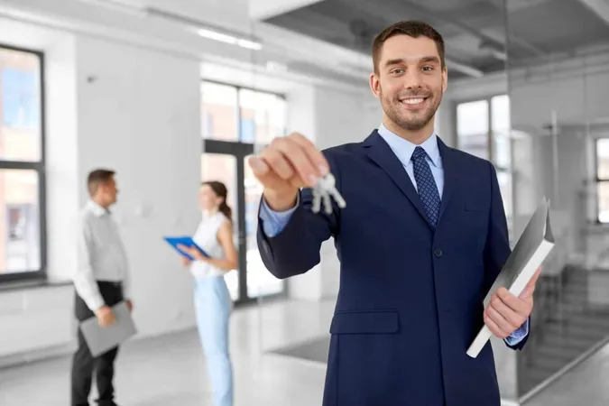 Smiling Realtor With Keys Folder New Office X - Certified Leasing Professional study guide