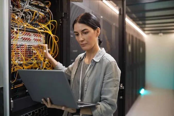Waist Up Portrait Female Network Engineer Connecting Cables Server Cabinet While Working With Supercomputer Data Center Copy Space X - Certified System Administrator study guide