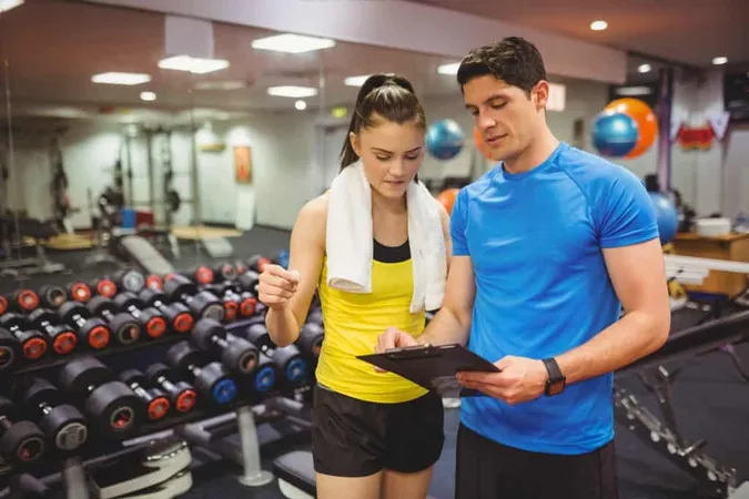 Trainer Client Discussing Her Progress X - National Exercise Trainers Association study guide