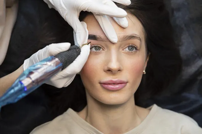 Young Woman Getting Beauty Treatment Her Eyebrows X - American Academy of Micropigmentation study guide