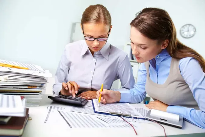 Businesswomen Reviewing Results X - Association of International Certified Professional Accountants study guide