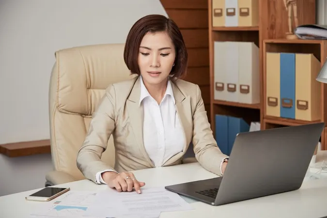 Ethnic Businesswoman Working With Paper X - Association of Legal Administrators CLM study guide