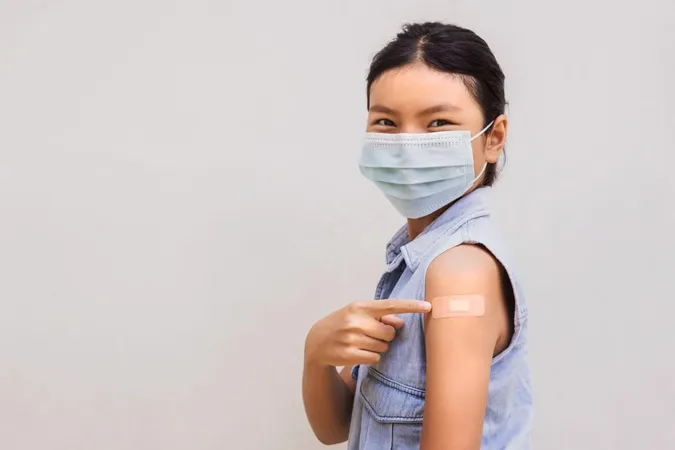 Portrait Young Female Pointing Plaster Arm After Getting Vaccine Standing White Background X - APhA Pharmacy-Based Immunization Certificate study guide