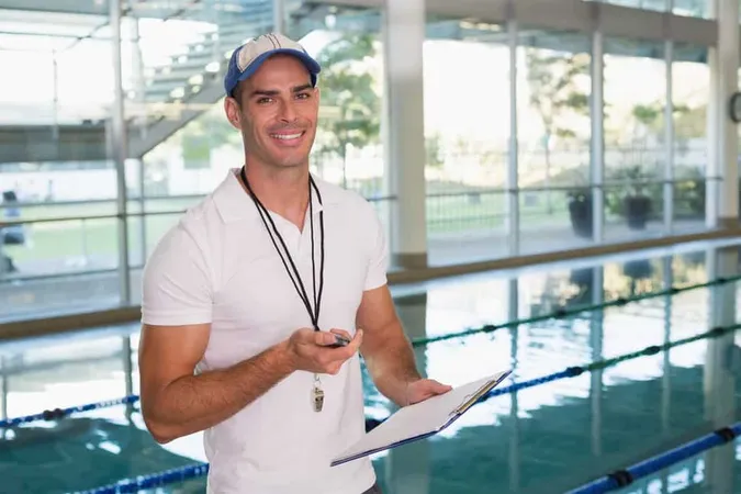 Swimming Coach With Stopwatch By Pool Leisure Center 1 - American Swimming Coaches Association Swimming Certification study guide