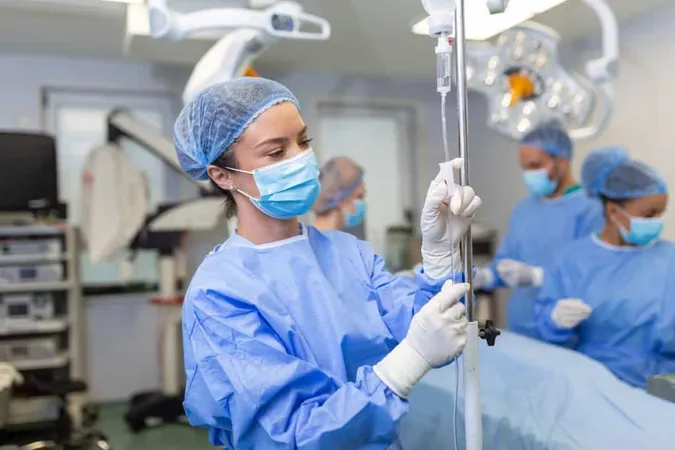Female Doctor Operating Room Putting Drugs Through Iv Surgery Concepts 1 X - Certified Anesthesia Assistant study guide