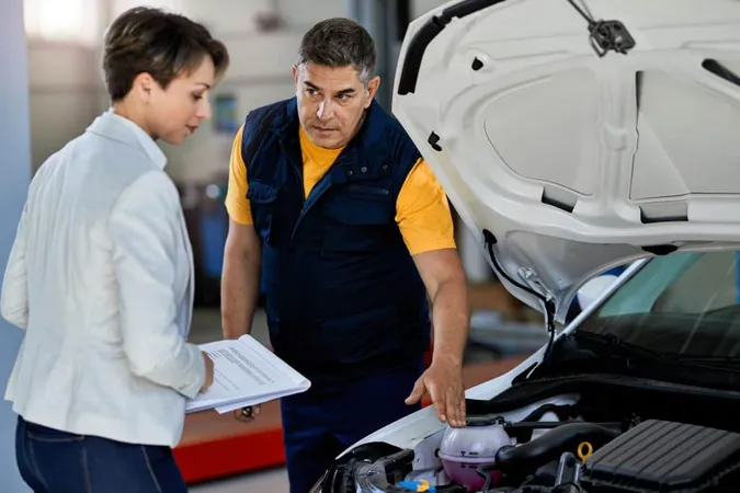 Car Mechanic Female Manager Talking While Examining Car Engine Breakdown Auto Repair Shop X - Certified Automotive Appraiser study guide