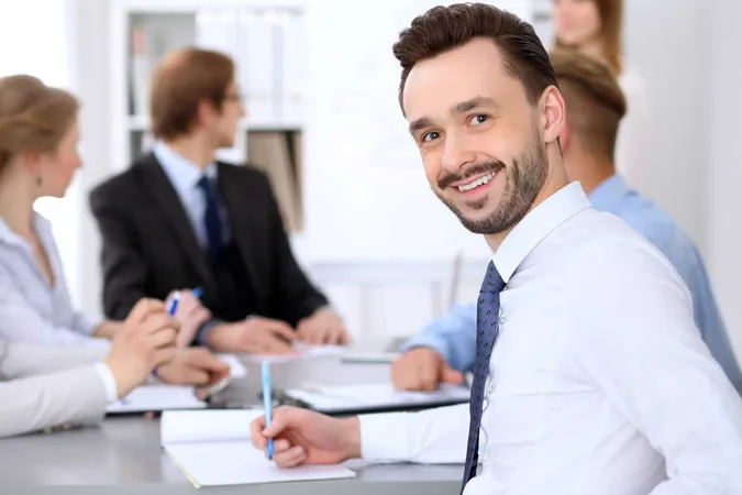 Portrait Cheerful Smiling Business Man Against Group Business People Meeting X - Certified Philanthropic Advisor study guide