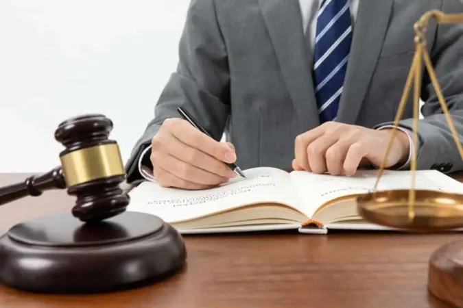 Closeup Shot Person Writing Book With Gavel Table 1 X - Certified Court Executive study guide