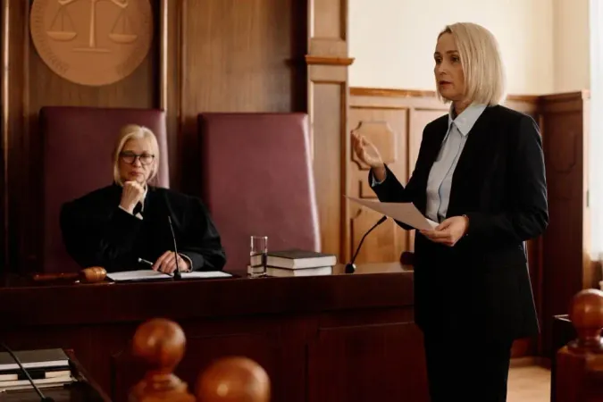 Confident Blond Female Prosecutor With Juridical Document Looking Suspect His Attorney X - Certified Court Executive study guide