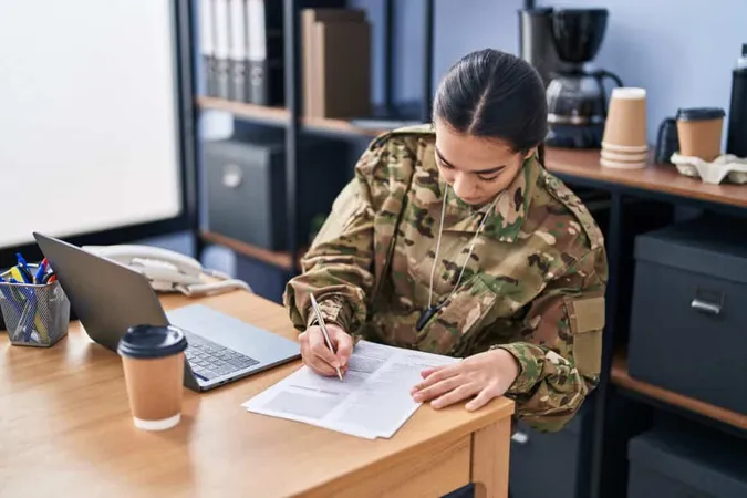 Young Hispanic Woman Army Soldier Using Laptop Writing Document Office 2 X - Certified Corrections Officer study guide