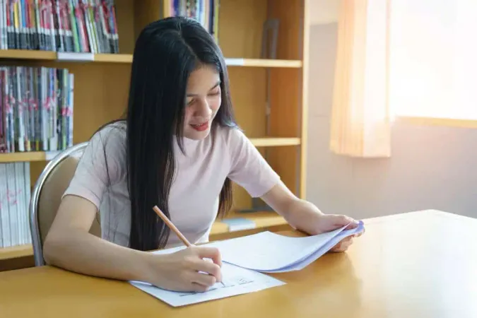 Young Woman Studying Table Home 1 - California Critical Thinking Skills Test study guide