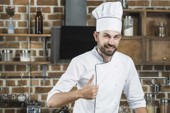 Smiling Young Man Standing Kitchen Showing Thumb Up Sign X - Certified Executive Chef study guide