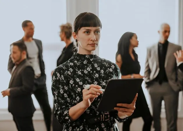 Empowering Businesswoman Using Digital Tablet - Certified Exhibition Manager study guide