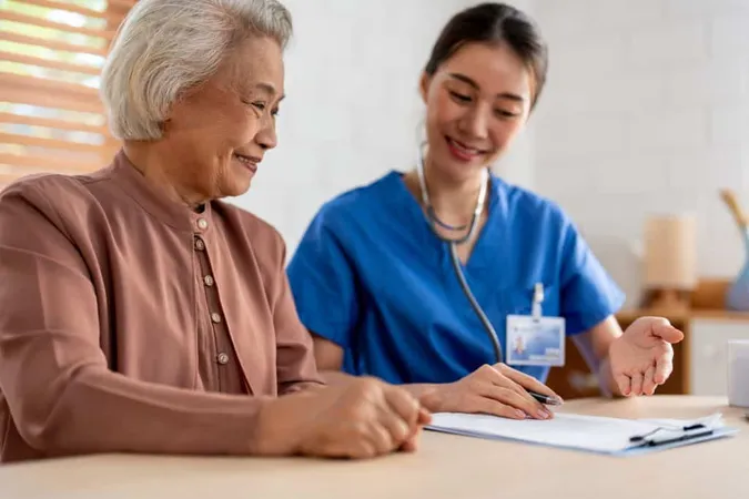 Asian Young Caregiver Nurse Examine Senior Woman Patient Home Attractive Specialist Carer Women Support Give Advise Consult With Older Elderly Mature Grandmother Living Room House X - Certified Assisted Living Administrator study guide