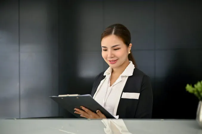 Beautiful Asian Female Receptionist Reading Checking Document Front Desk X - Certified Hospitality Administrator study guide