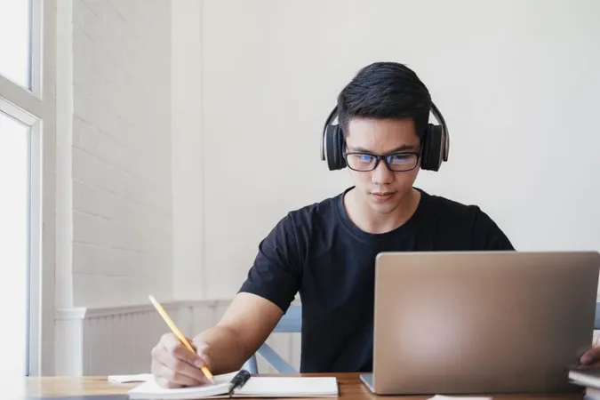 Young Man Study Home Using Laptop Learning Online X - Certified Legal Transcriptionist study guide