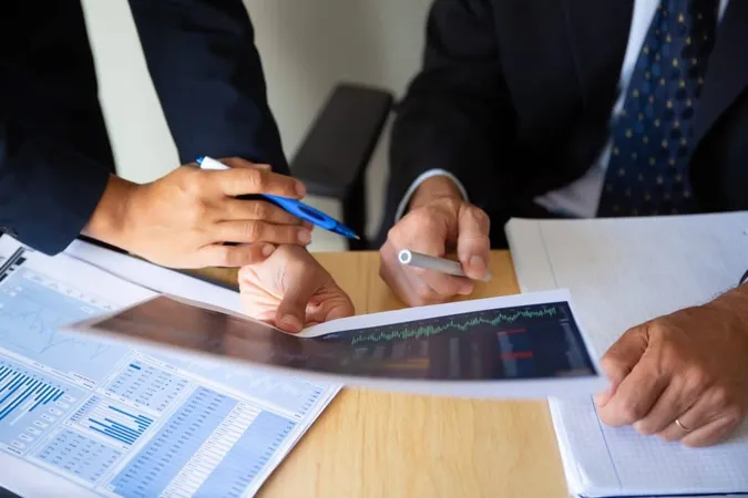 Investor Broker Discussing Trading Strategy Holding Papers With Financial Charts Pens Cropped Shot Broker Job Investment Concept X - Certified Financial Examiner study guide