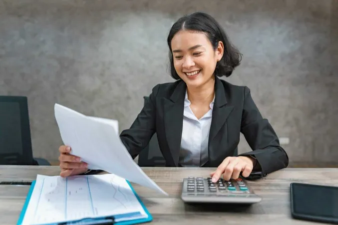 Woman Accountant Using Calculator Calculate Finance Report Office 1 X - Certified General Accountant study guide