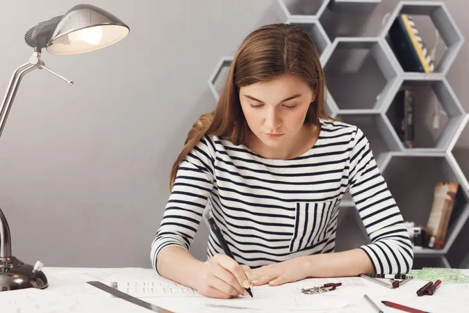 Close Up Portrait Young Serious Architect Girl Doing Her Work Cosy Coworking Space Looking Paper With Serious Unhappy Expression X - Certified Handwriting Analyst study guide