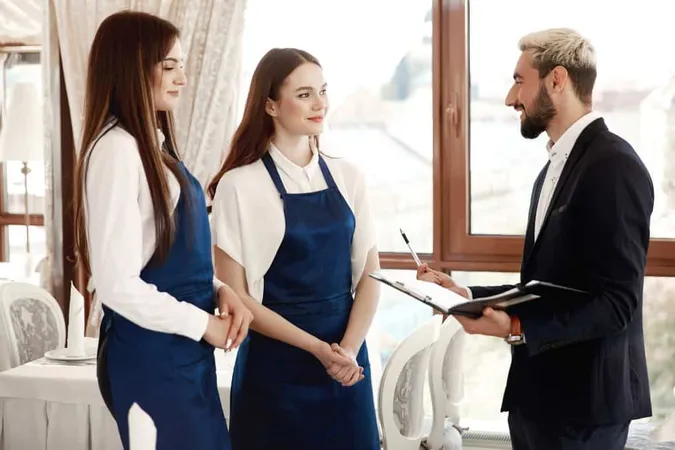 Handsome Restaurant Manager Is Talking Waitresses About Work Process X - Certified Hospitality Instructor study guide
