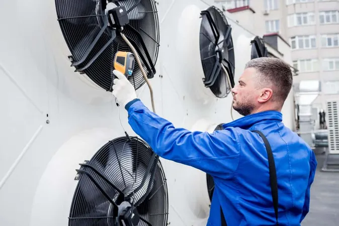 Technician Uses Thermal Imaging Infrared Thermometer Check Condensing Unit Heat Exchanger X - Certified Building Maintenance Manager study guide
