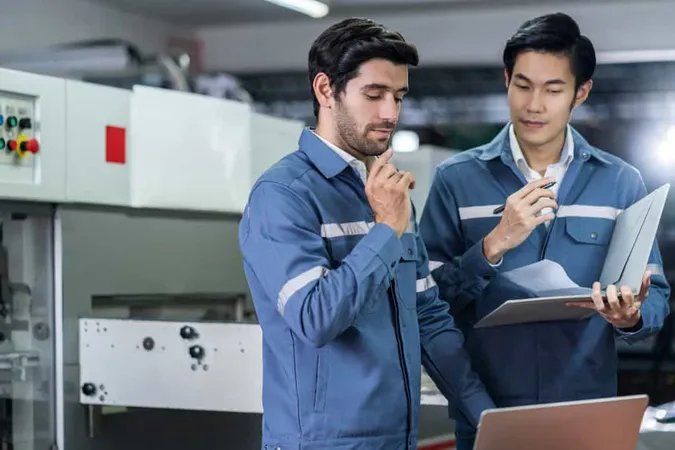 Male Asian Caucasian Engineer Professional Having Discussion Standing Consult Machine Factory Two Expert Coworker Brainstorm Explaining Solves Process Cnc Operate Machine 1 X - Certified Process Technician study guide
