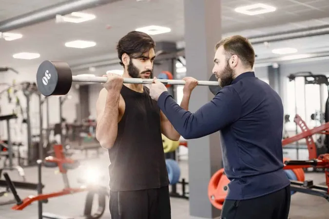 Indian Man Doing Excercisses Special Equipment Gym With Personal Trainer 1 X - CrossFit Level 1 Trainer Certification study guide