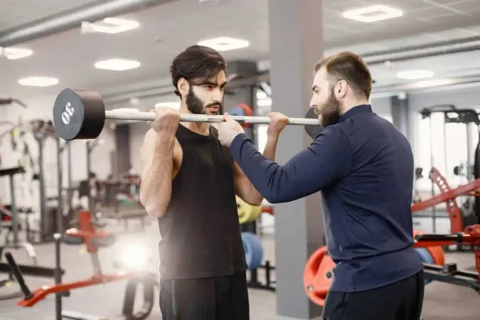 Indian Man Doing Excercisses Special Equipment Gym With Personal Trainer - Certified Strength &amp; Conditioning Specialist study guide