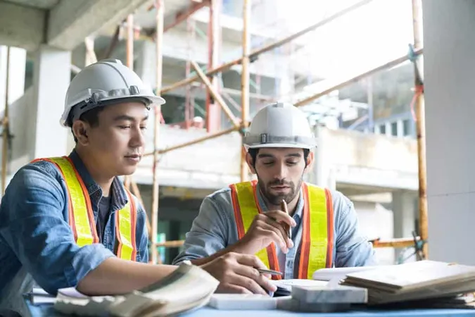 Young Asian Engineers Caucasian Engineer Colleagues Site Inspector Discuss Together Using Notebook Computer Paper Blueprint Building X - Construction Specifications Institute Certification study guide