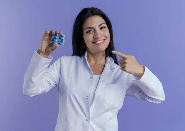 Smiling Young Female Doctor Wearing Medical Robe Holding Pointing Pack Medical Capsules Looking X - Certified Specialty Pharmacist study guide
