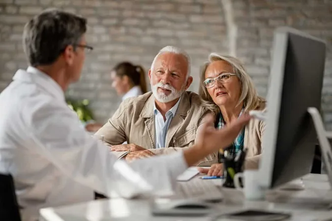 Senior Couple Talking With Doctor About Their Medical Records While Having Consultations Clinic X - Certified Senior Specialist study guide