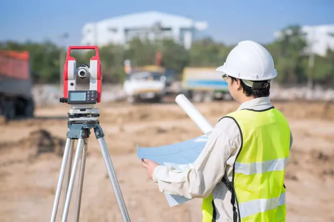 Construction Engineer Checking Construction Drawing Site Area X - Certified Survey Technician study guide