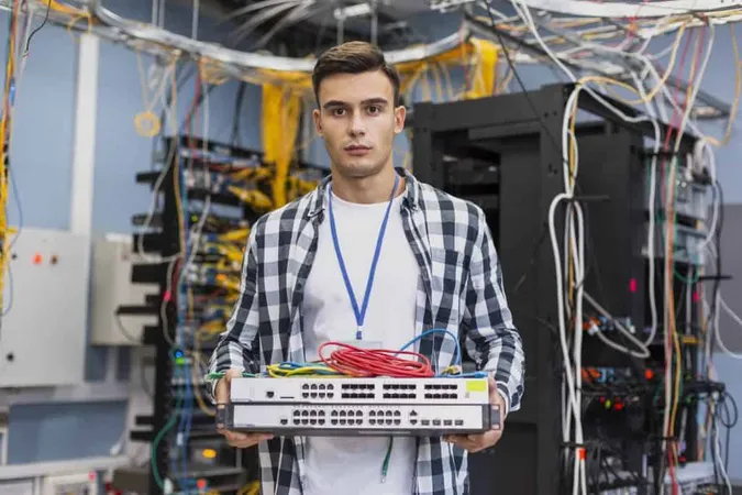 Young Man Holding Ethernet Switches X - Certified Telecommunications Engineer study guide