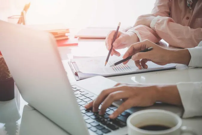 Business Team Analyzing Income Charts X - Certified Underwriter study guide