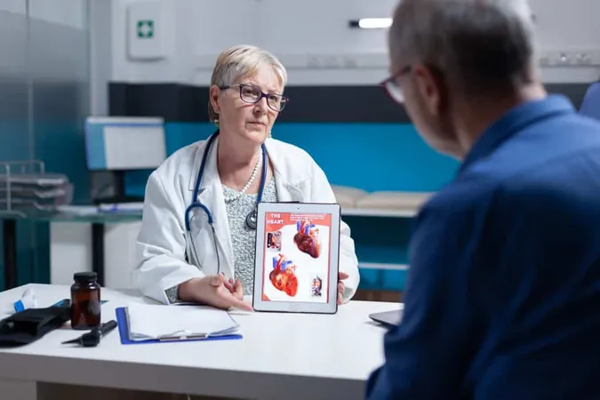 Physician Explaining Cardiology Diagnosis With Heart Organ Tablet Patient General Practitioner Showing Illustration Cardiovascular System Anatomical Structure Man X - Emergency Cardiovascular Care Certification study guide