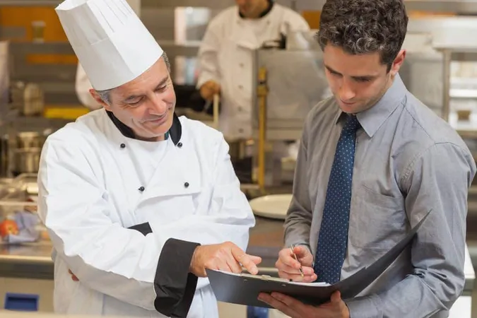 Head Chef Waiter Discussing Menu Kitchen - General study guide
