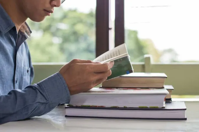 Business Man Sitting Table Readi - GRE study guide