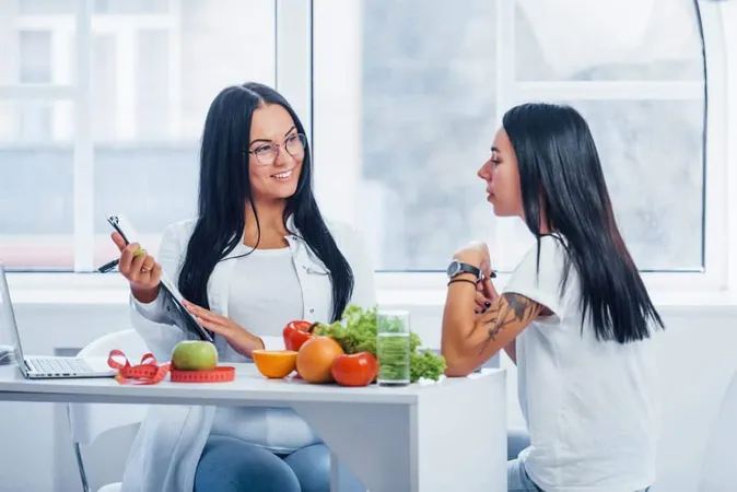 Female Nutritionist Gives Consultation Patient Indoors Office By Using Notepad X - Institute for Integrative Nutrition Certification study guide