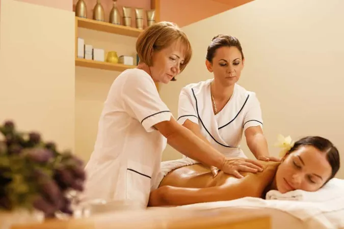 Serene Woman Getting Back Massage By Two Therapists Spa Treatment X - Licensed Massage Therapists study guide