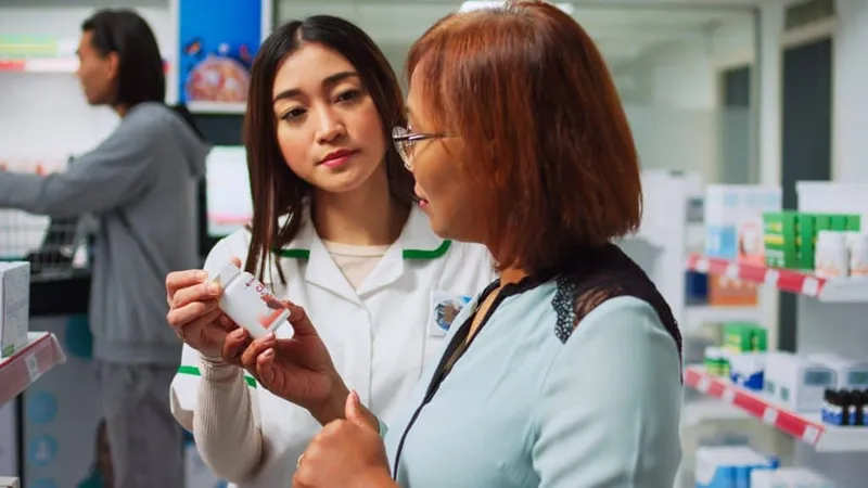 Drugstore Assistant Helping Customer With Pills Treatment Medicine Pharmacy Shop Specialist Explaining Prescription Drugs Vitamins Client Employee Looking Medicaments Box X - Certified Medication Attendant study guide
