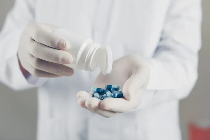Side View Doctor With Gloves Holding Pills Bottle Horizontal X - Medication Compounding Certification study guide